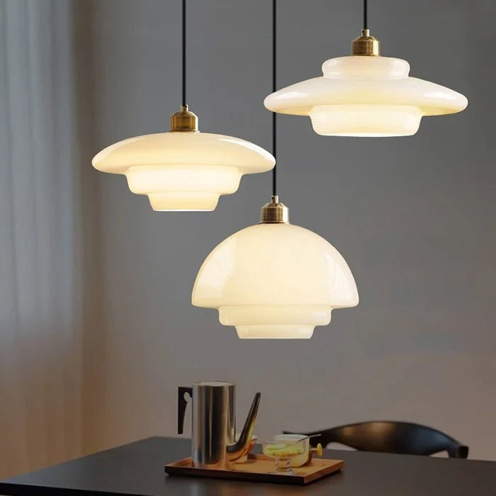 Stylish modern pendant light featuring glass and brass accents, ideal for kitchen settings. Dimensions: 12 x 12 x 16 inches. Lur 3
