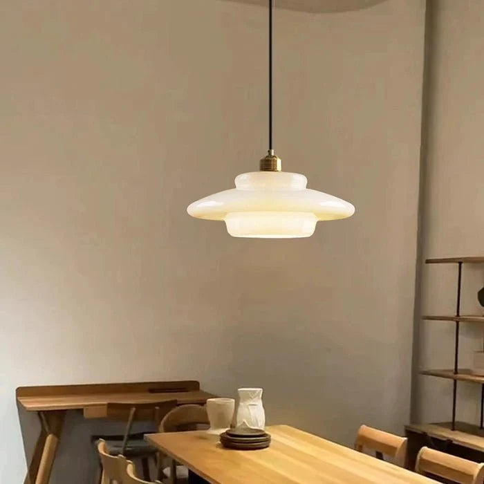 Stylish modern pendant light featuring glass and brass accents, ideal for kitchen settings. Dimensions: 12 x 12 x 16 inches. Lur 6