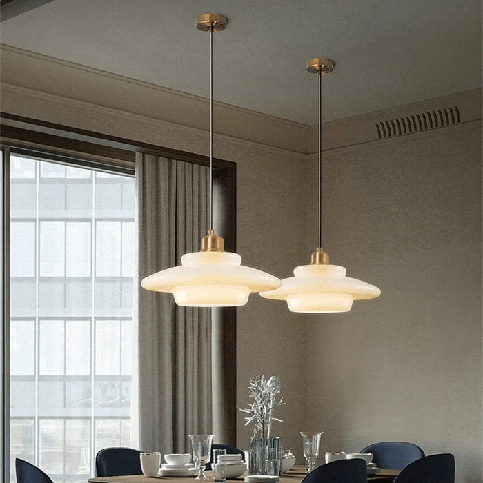 Stylish modern pendant light featuring glass and brass accents, ideal for kitchen settings. Dimensions: 12 x 12 x 16 inches. Lur 7