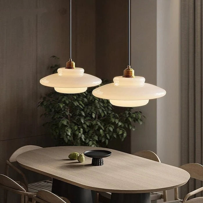 Stylish modern pendant light featuring glass and brass accents, ideal for kitchen settings. Dimensions: 12 x 12 x 16 inches. Lur 8