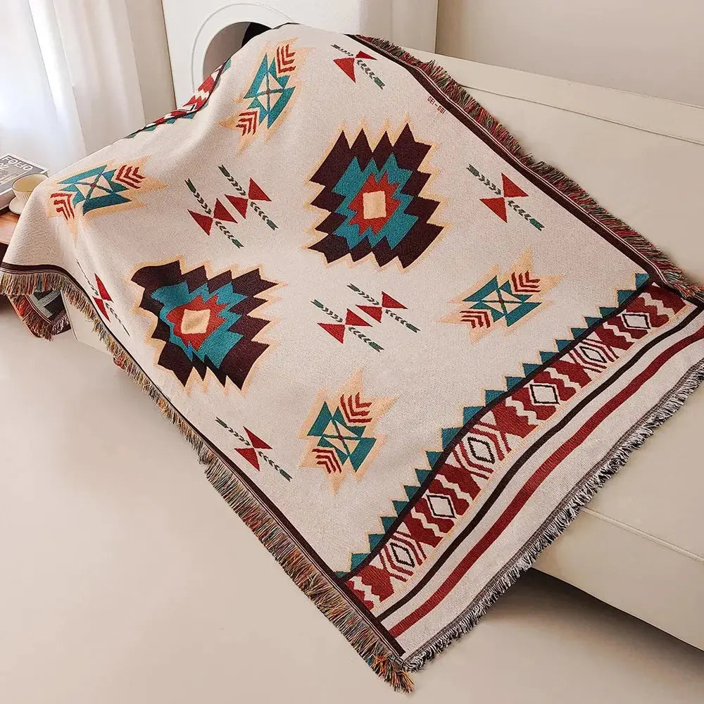 Aztec woven throw blanket draped over sofa