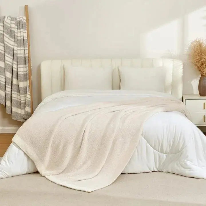 Beige knit throw blanket on bed