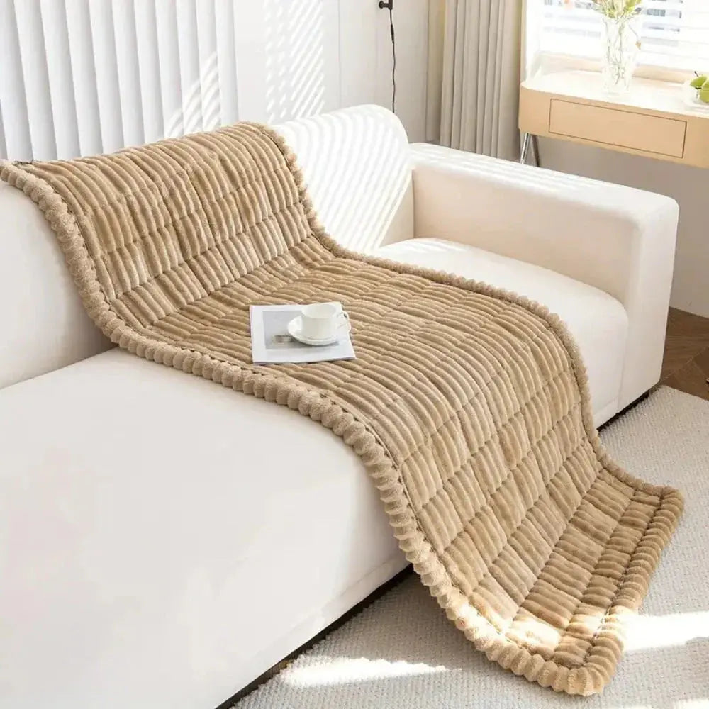 Beige plush sofa seat protector draped over couch