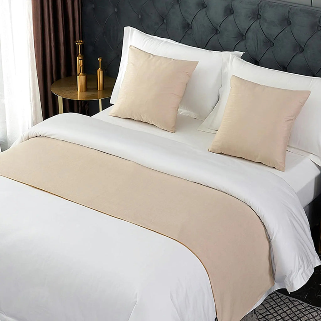 Beige velvet bed runner on bed
