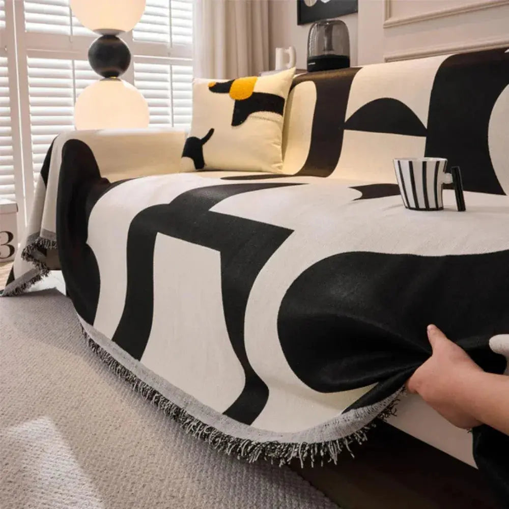 Black and cream geometric couch cover with fringe