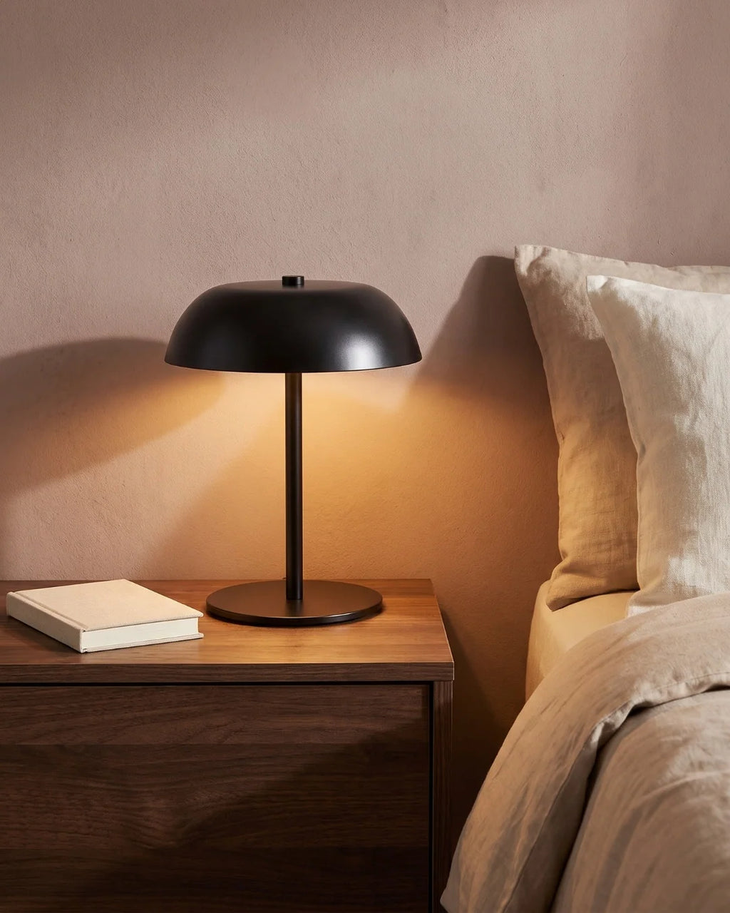 Black cordless lamp on nightstand