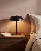 Black cordless lamp on nightstand