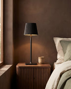 Black cordless lamp on nightstand