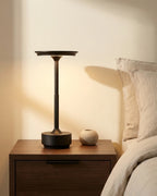Black cordless lamp on nightstand