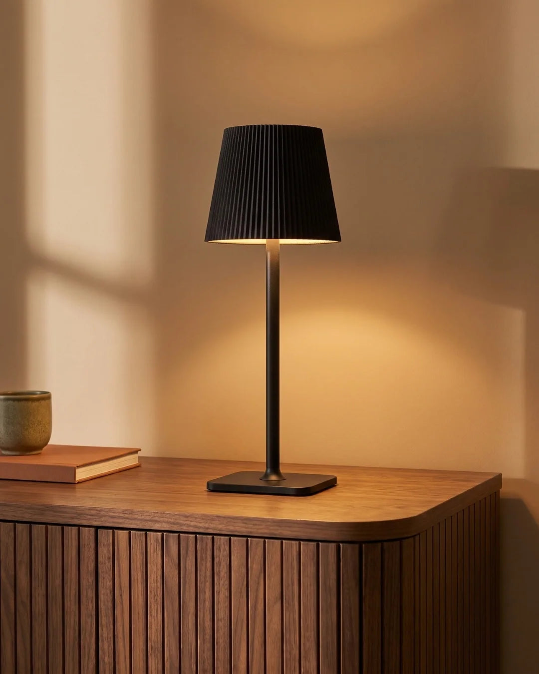 Black cordless lamp on sideboard