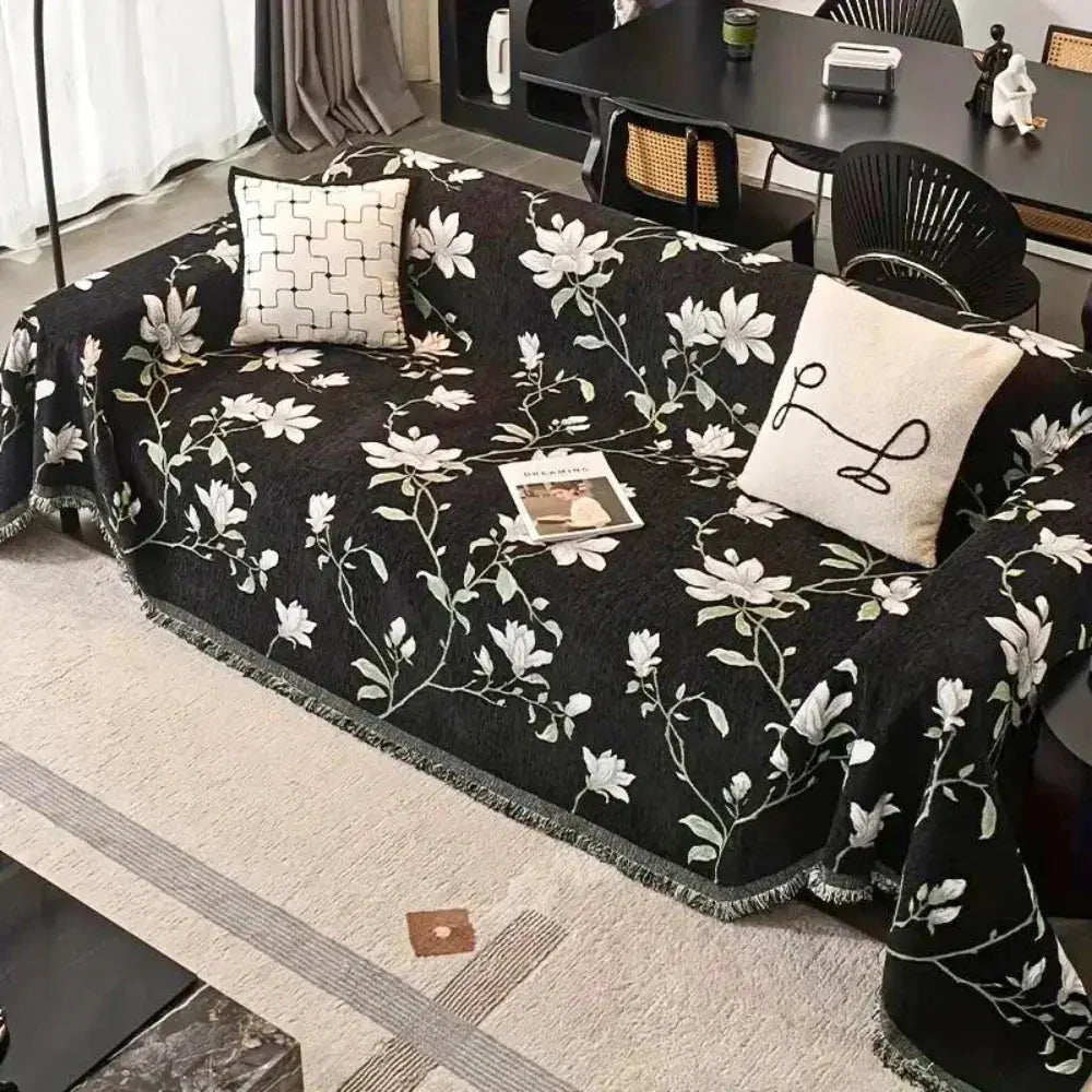 Black floral chenille couch cover with tassels on sofa