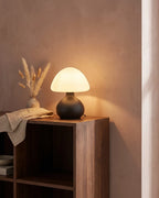 Black mushroom lamp on bedside shelf