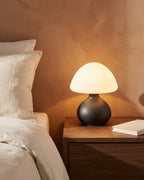 Black mushroom lamp on nightstand