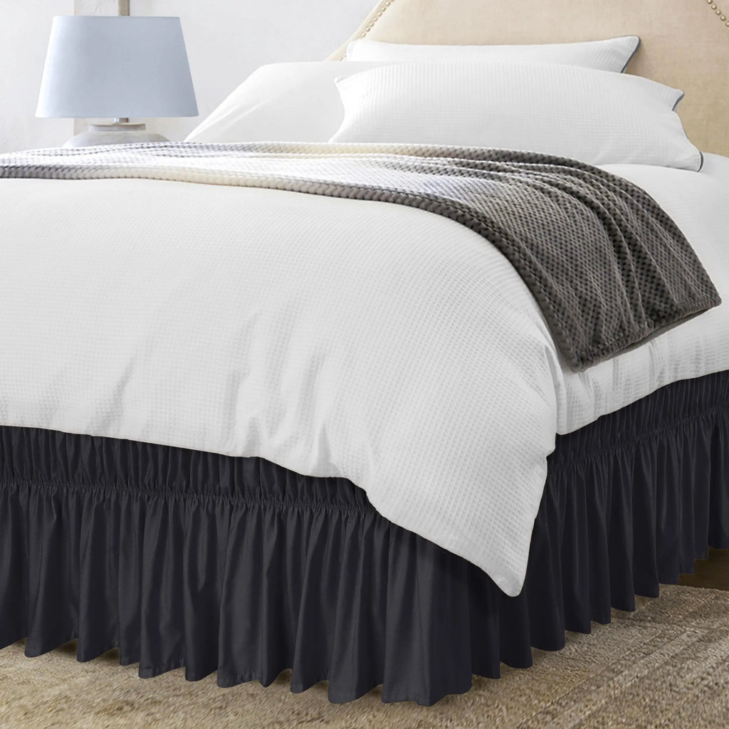 Black ruffled bed skirt on bed