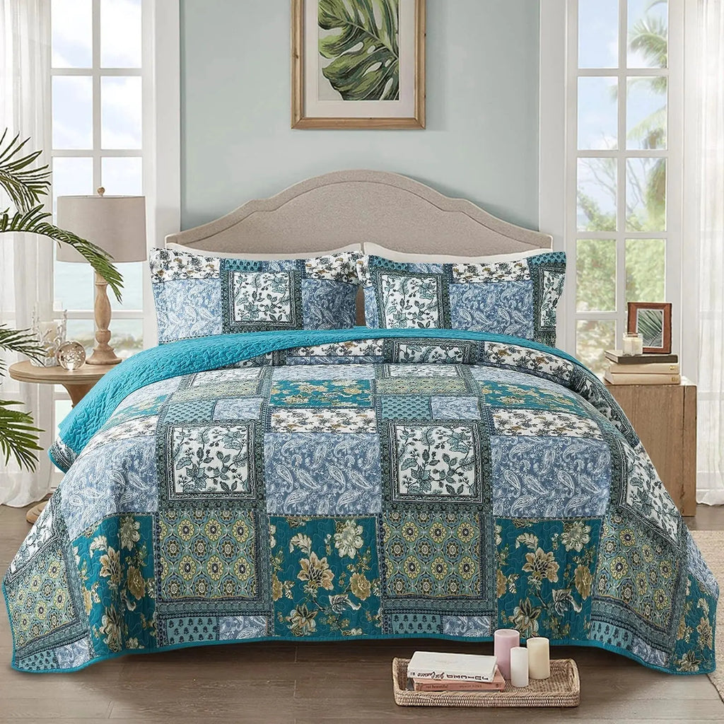 Blue and teal floral patchwork quilt set on bed
