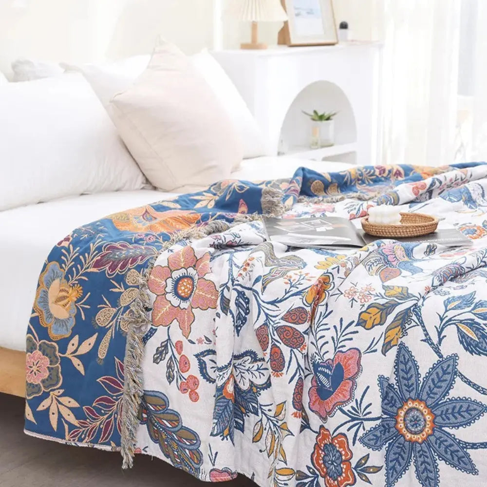 Blue floral throw blanket on bed