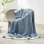 Blue knit throw blanket draped over chair