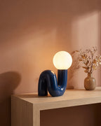 Blue sculptural lamp on console