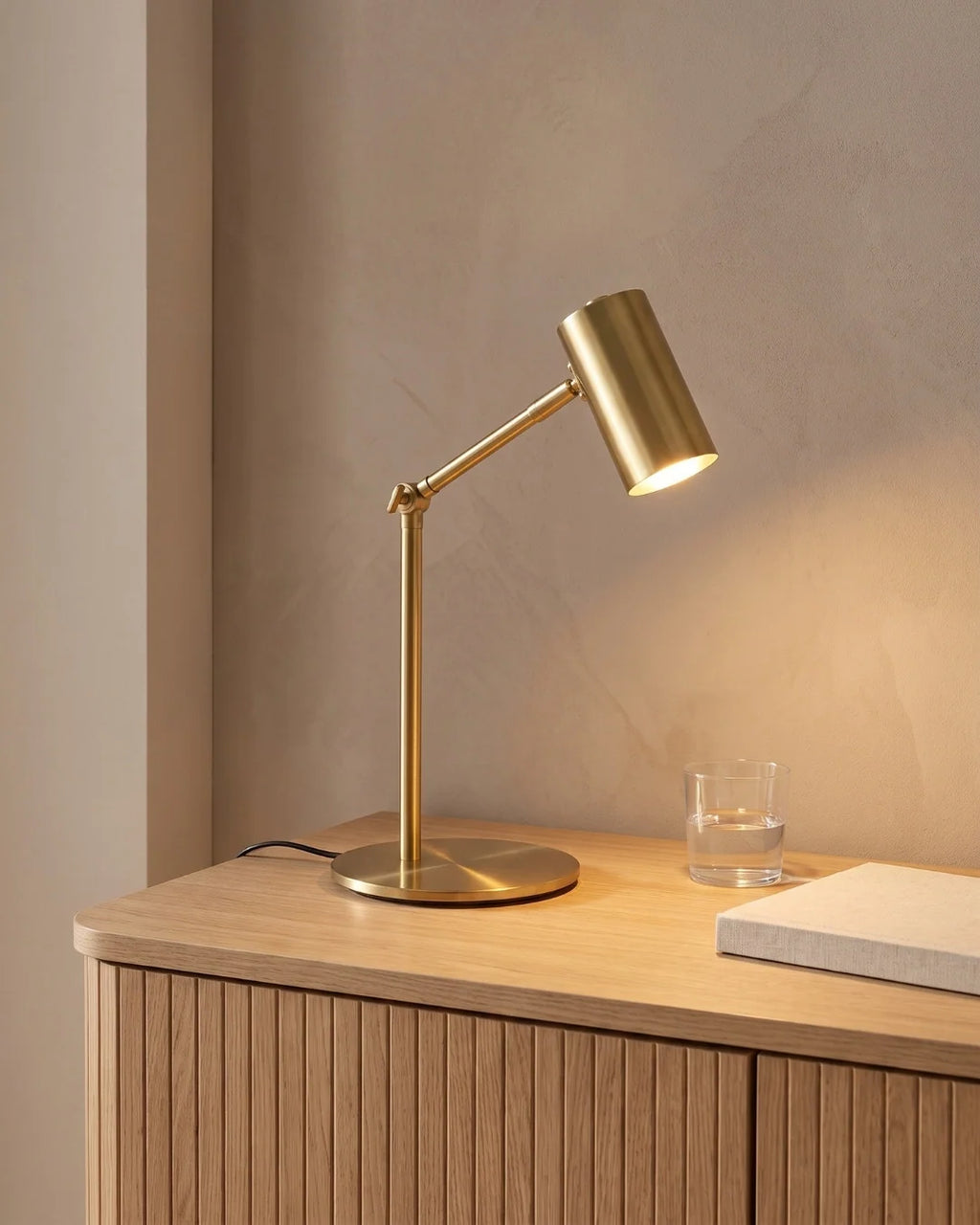 Brass reading lamp on sideboard
