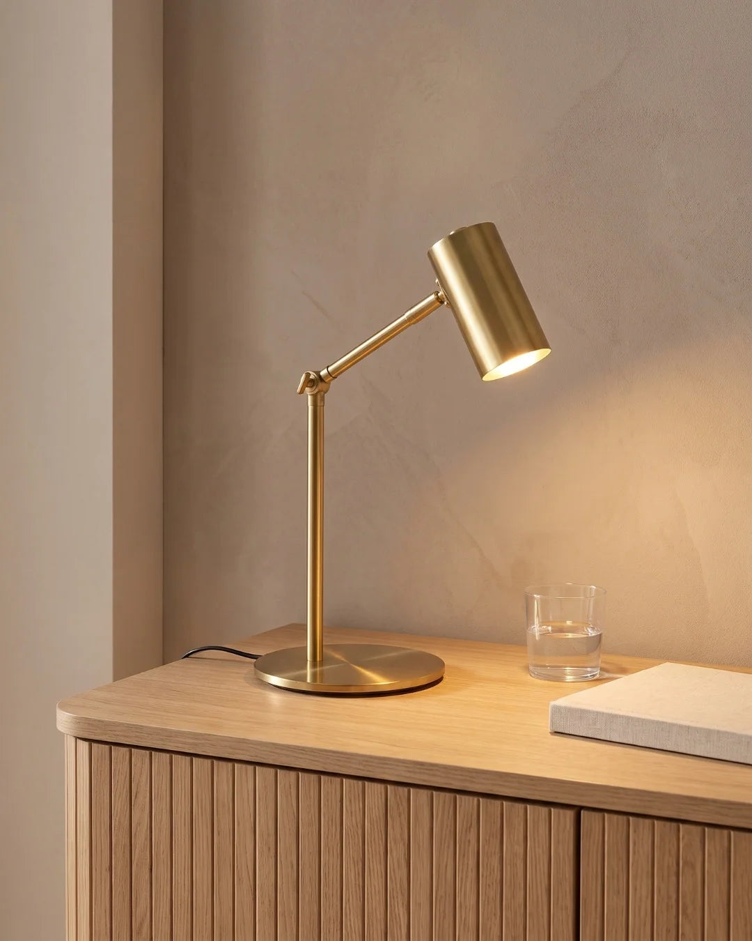 Brass reading lamp on sideboard