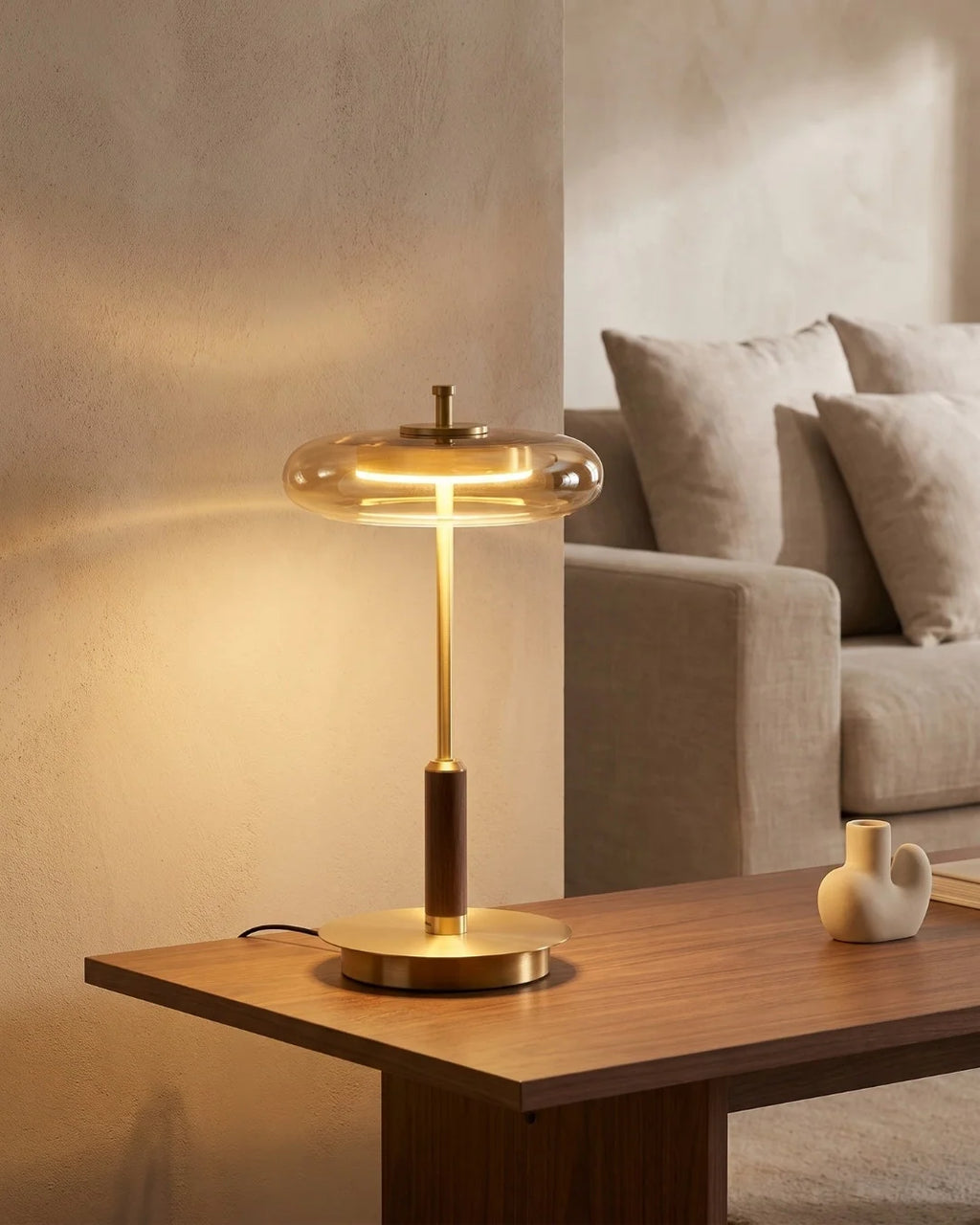 Brass table lamp on side table by sofa