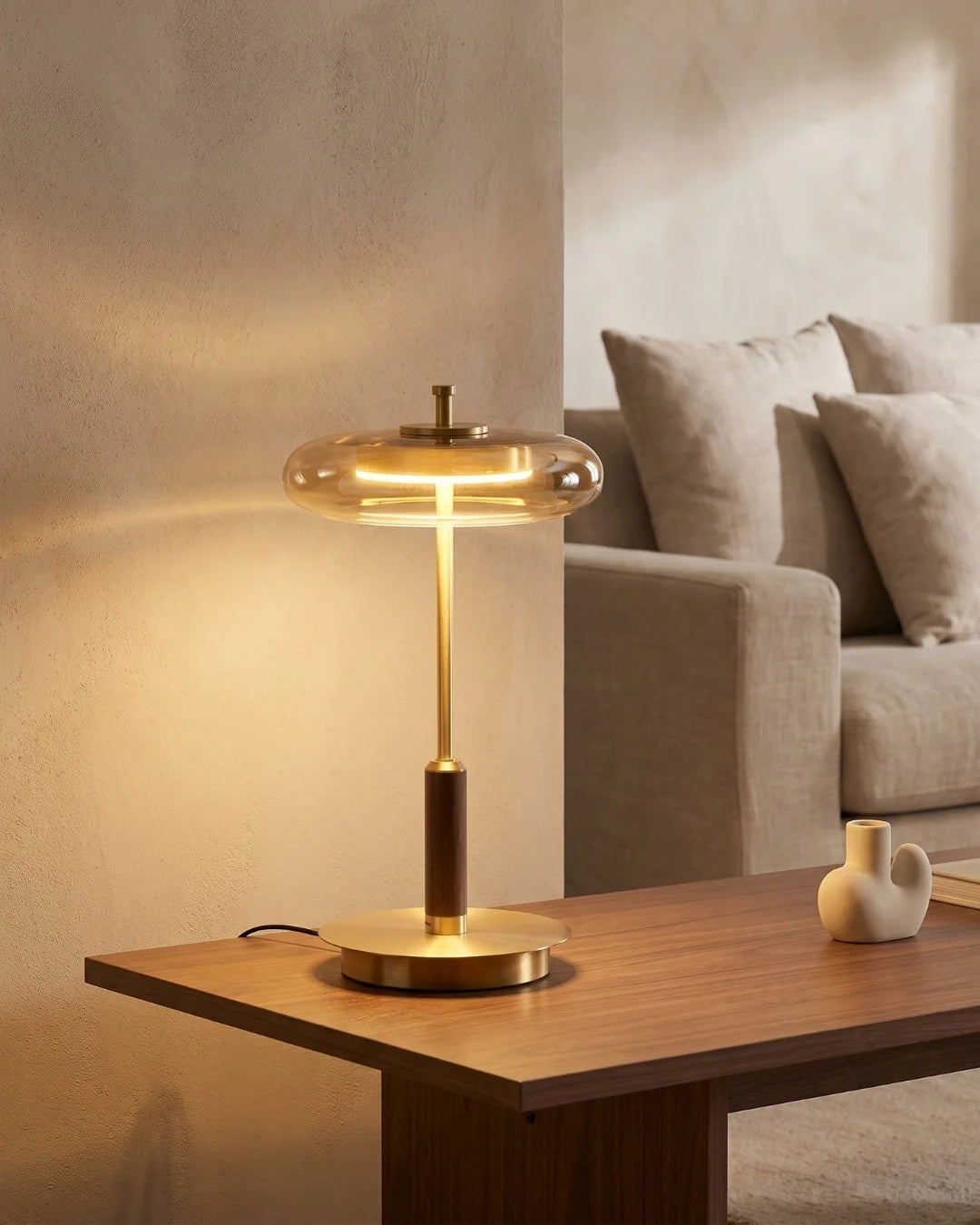 Brass table lamp on side table by sofa