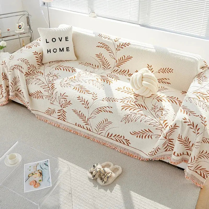 Brown and orange leaf chenille couch cover on sofa