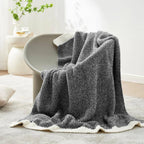 Charcoal reversible knit throw on chair