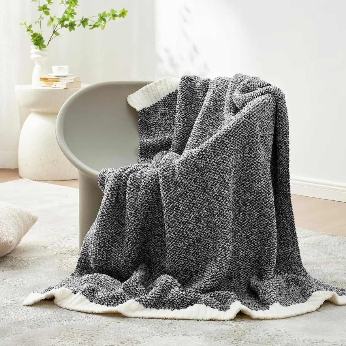Charcoal reversible knit throw on chair