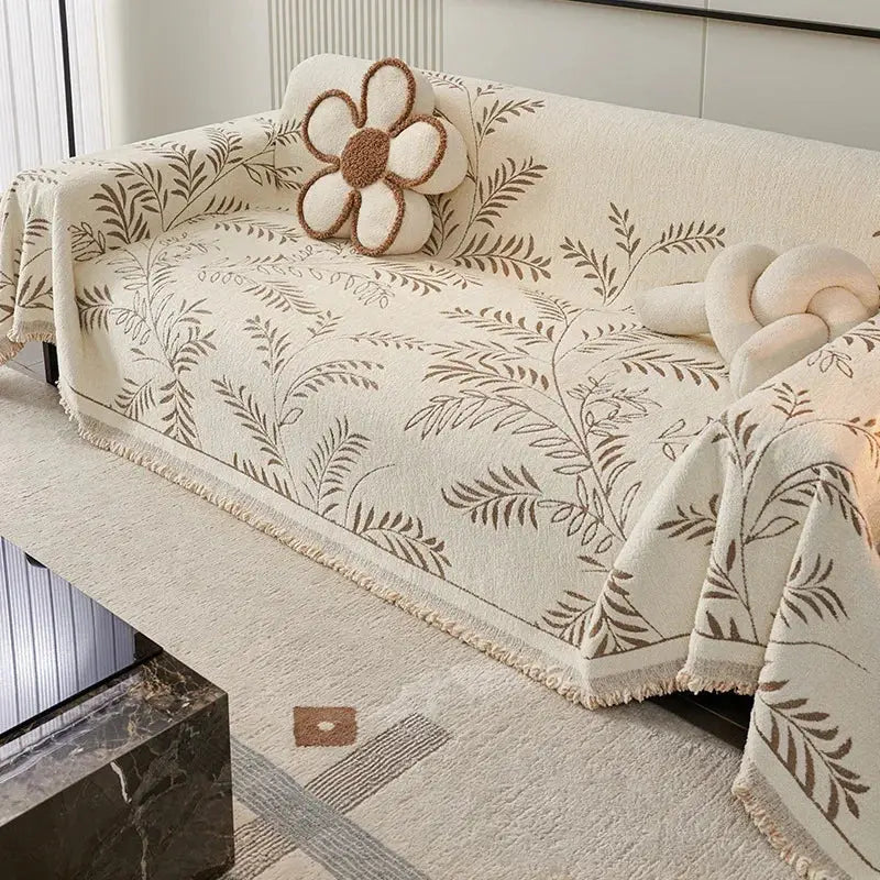 Chenille couch cover with gray-green leaf pattern