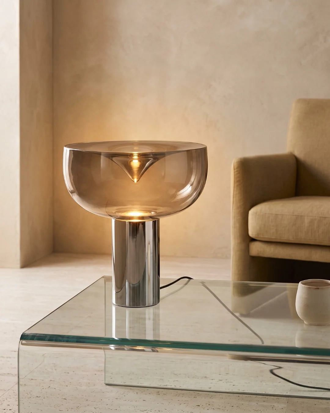 Chrome table lamp on glass coffee table