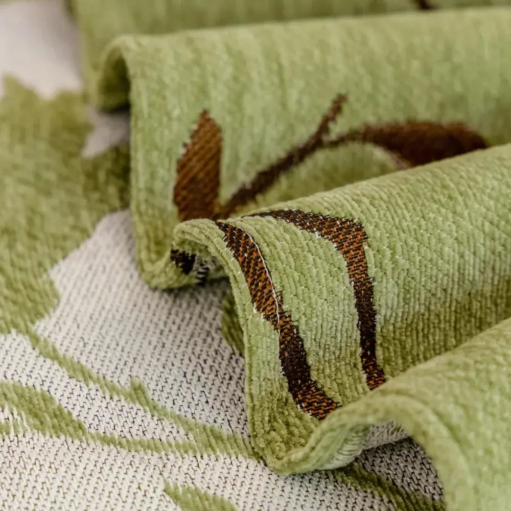 Close-up of green chenille fabric with woven floral pattern
