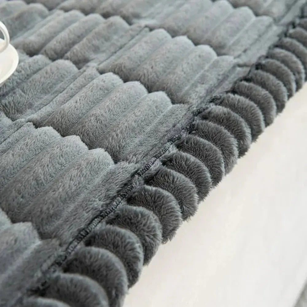 Close-up of pleated edge on gray plush couch cover