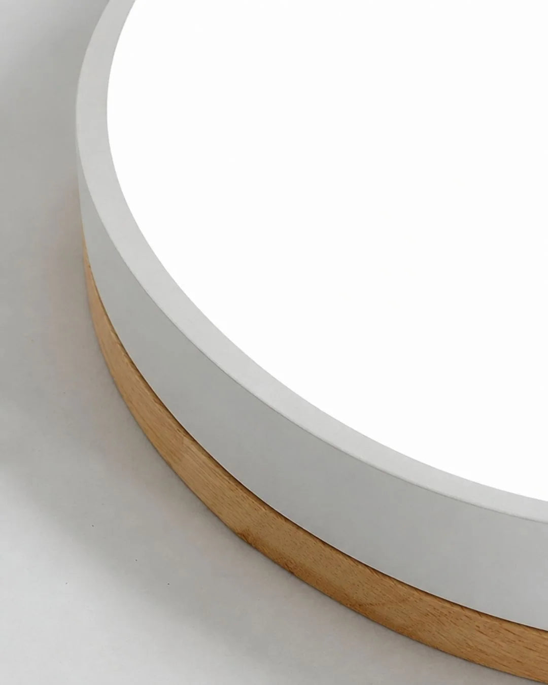 Close-up of white diffuser and wood ring