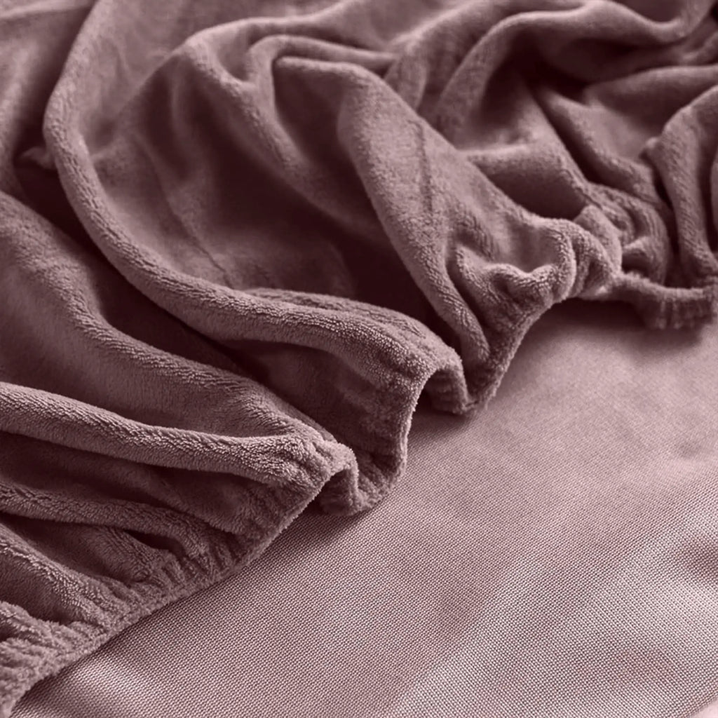 Corner of mauve velvet fitted sheet