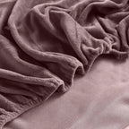 Corner of mauve velvet fitted sheet
