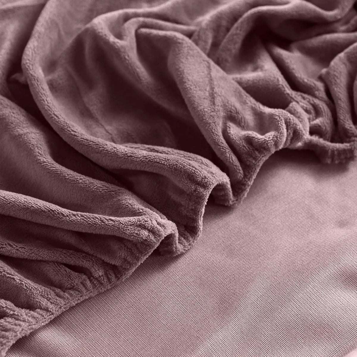 Corner of mauve velvet fitted sheet
