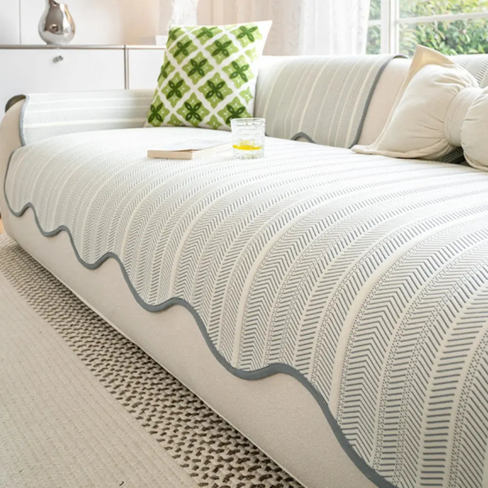 Herringbone couch cover with gray scalloped edge on sofa