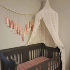 Cream canopy over crib