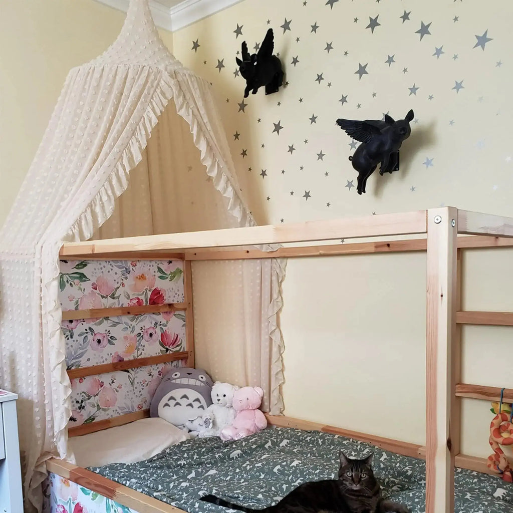 Cream canopy over toddler bed