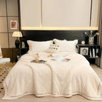 Cream embossed fleece blanket on bed