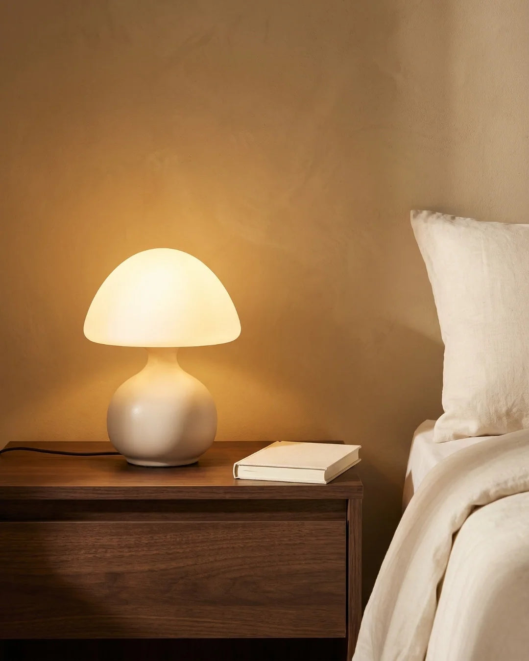Cream mushroom lamp on nightstand
