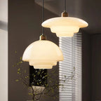 Dome and tiered glass pendant lights in dining room