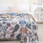 Floral cotton throw blanket on bed