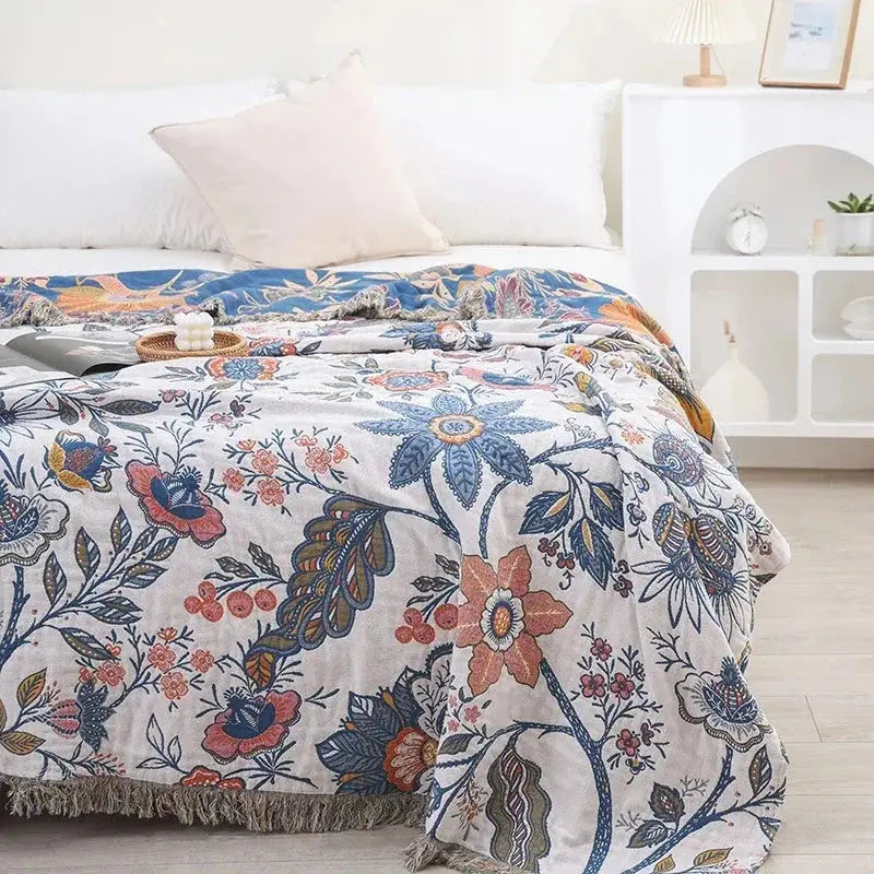 Floral cotton throw blanket on bed