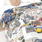 Floral throw blanket with book on bed