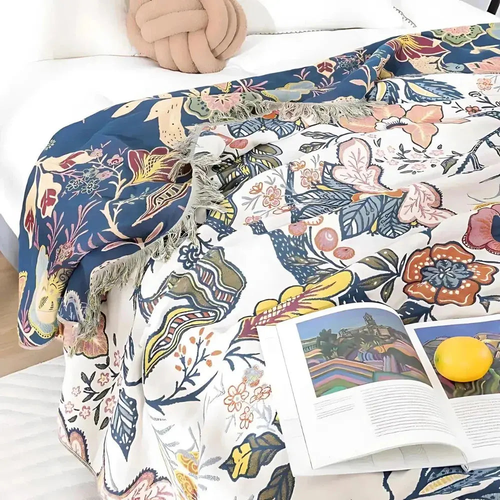 Floral throw blanket with book on bed