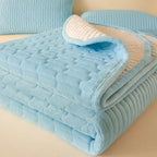 Folded sky blue quilted coverlet