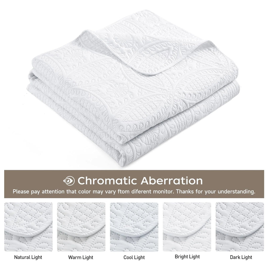 Folded white quilt and color guide
