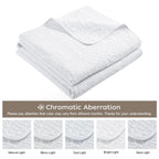 Folded white quilt and color guide